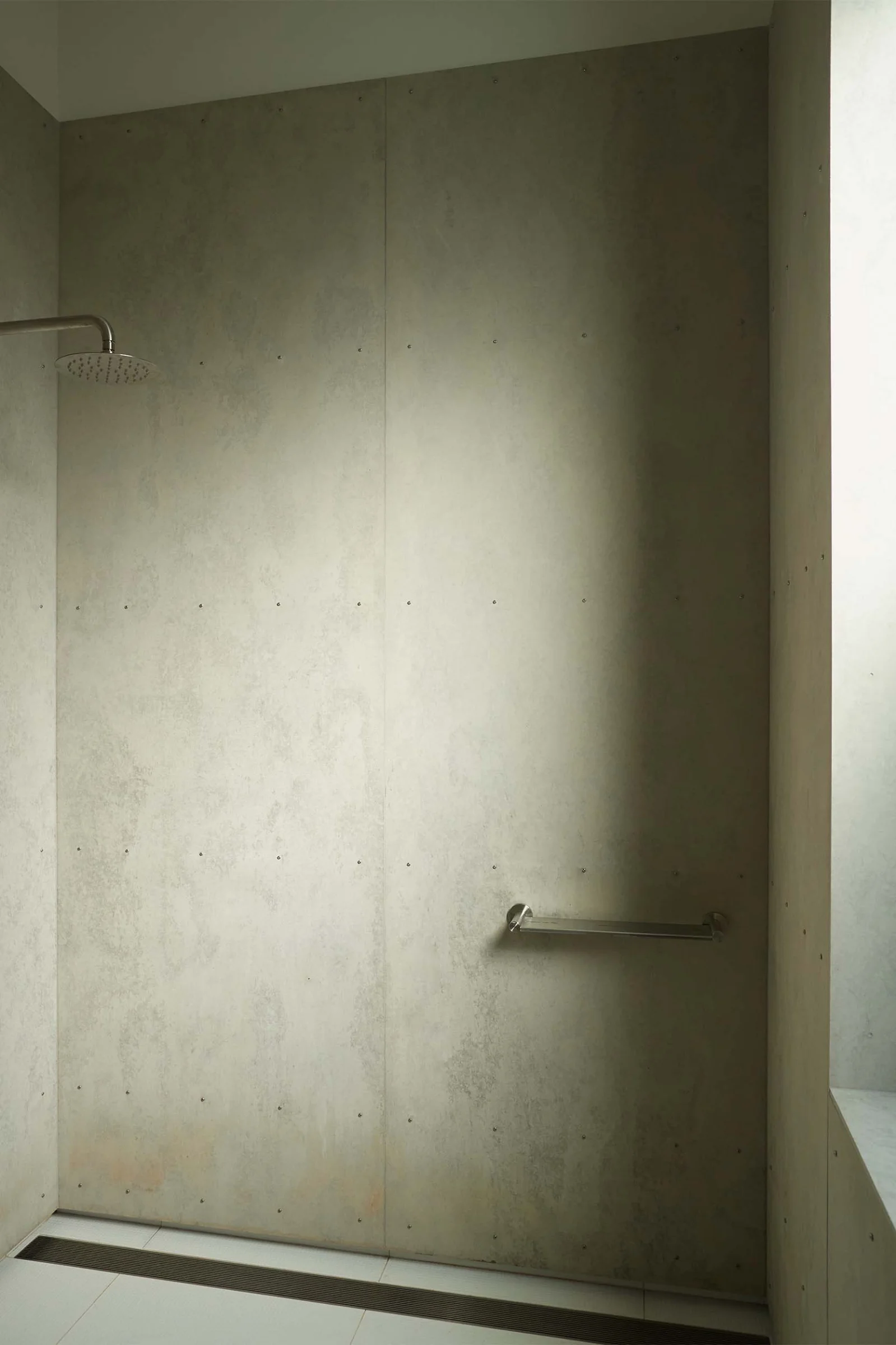 Cement sheet cladding to bathroom at Economy House 1 by Office of Alexei Haddad