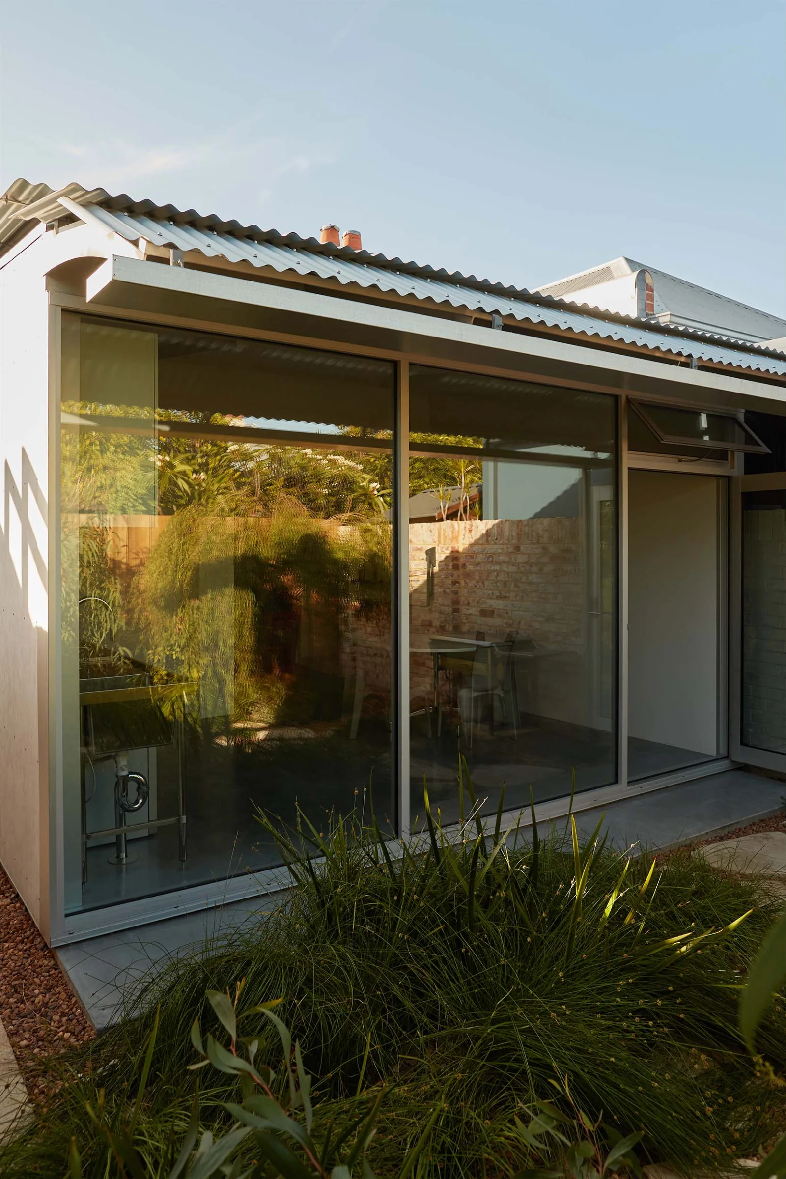 Traditional workers cottage with lean-to addition at Economy House 1 by Office of Alexei Haddad